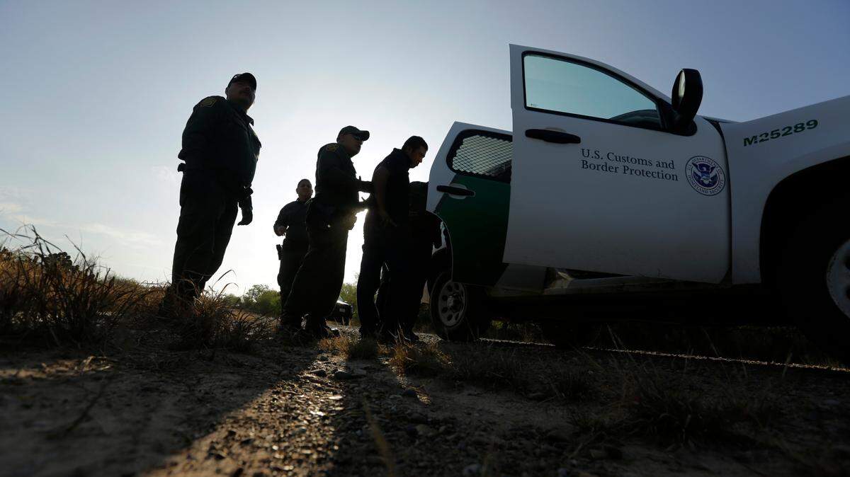 Border Patrol agents stop men thought to have entered the country illegally, near McAllen, Texas, along the U.S.-Mexico border in November 2019.