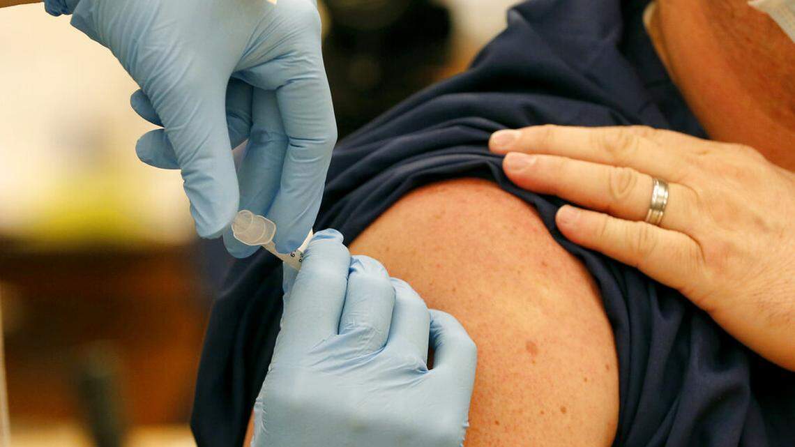 A Pfizer-BioNTech COVID-19 vaccine is given to an Ohio State employee Monday, Dec. 14, 2020, in Columbus, Ohio. (AP Photo/Jay LaPrete)