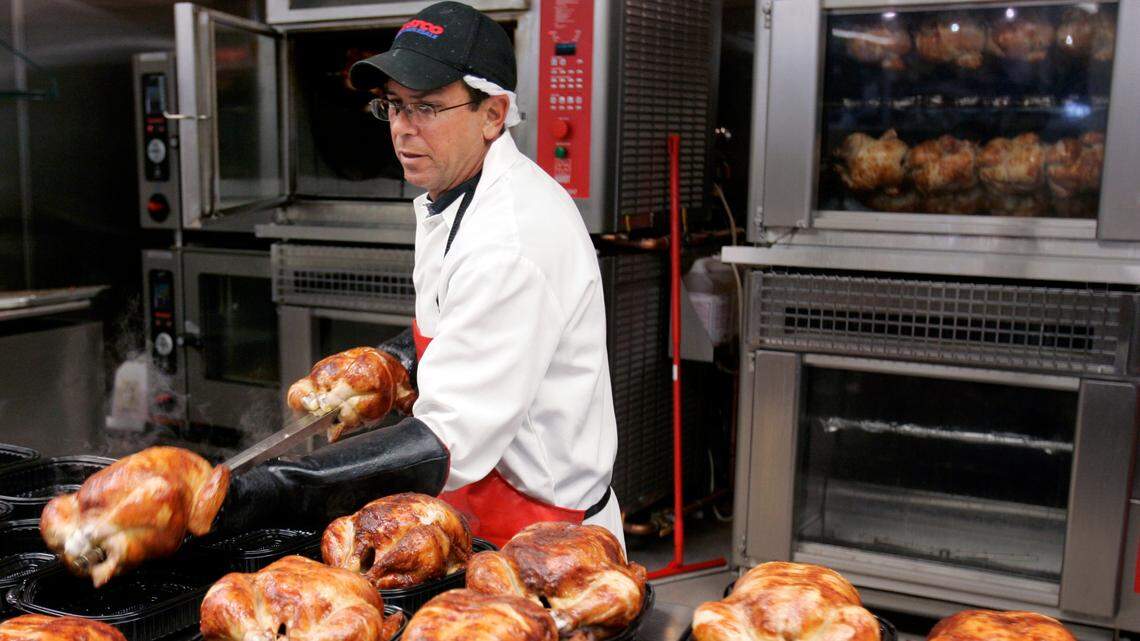 In this May 8, 2008, file photo, a butcher spreads out rotisserie-roasted chicken at Costco in Mountain View, Calif. In 2022, two Costco shareholders sued the company, saying it “mistreats and neglects” the chickens it breeds.