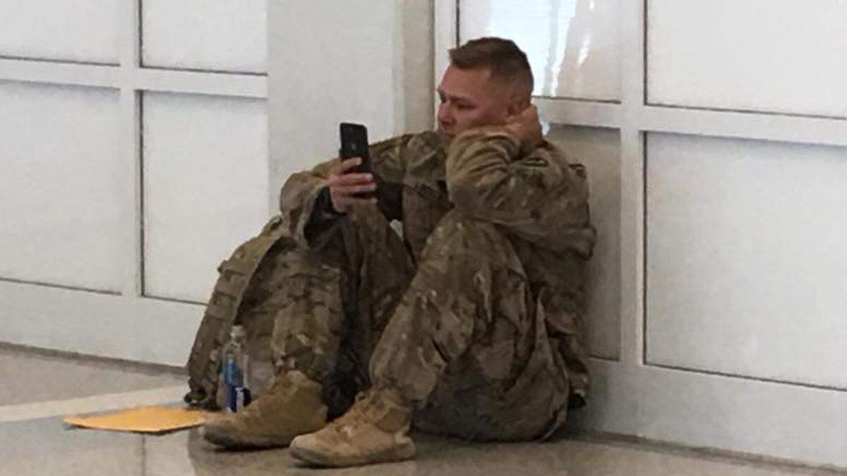 Brooks Lindsey watches the birth of his daughter Millie on Facetime from Terminal B at DFW International Airport during a flight delay Saturday, May 5.