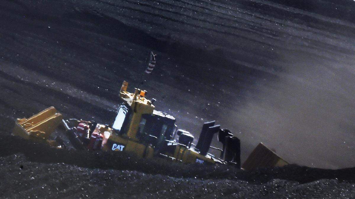 Heavy equipment is used to dig through coal to look for the bodies of two people who were buried at the Comanche Generating Station in Pueblo, Colo., Thursday, June 2, 2022. (Jerilee Bennett/The Gazette via AP)
