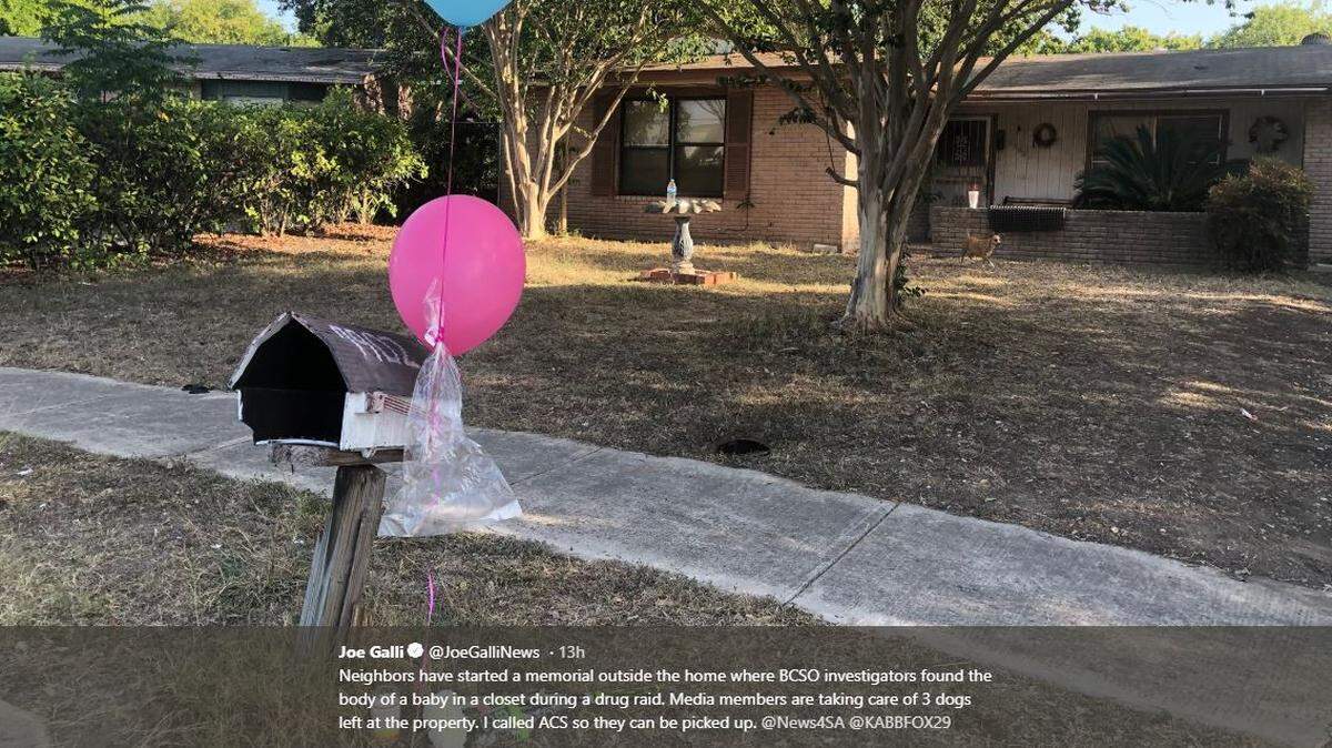 Gifts and balloons were placed near the mailbox of the home where a baby's desiccated remains were found in a piece of luggage during a drug raid.