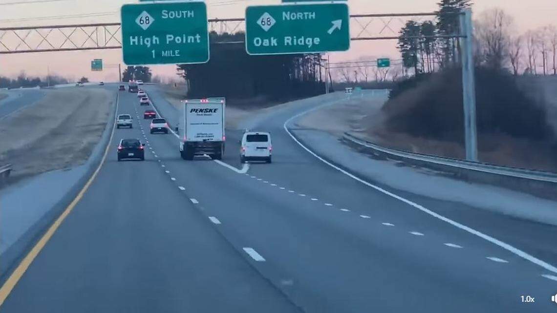 Video shared on social media showed two drivers engaged in an apparent road rage fight while driving recklessly on Highway 68 near High Point, North Carolina, on Feb. 9, 2022. The N.C. Highway Patrol said both drivers now face charges.