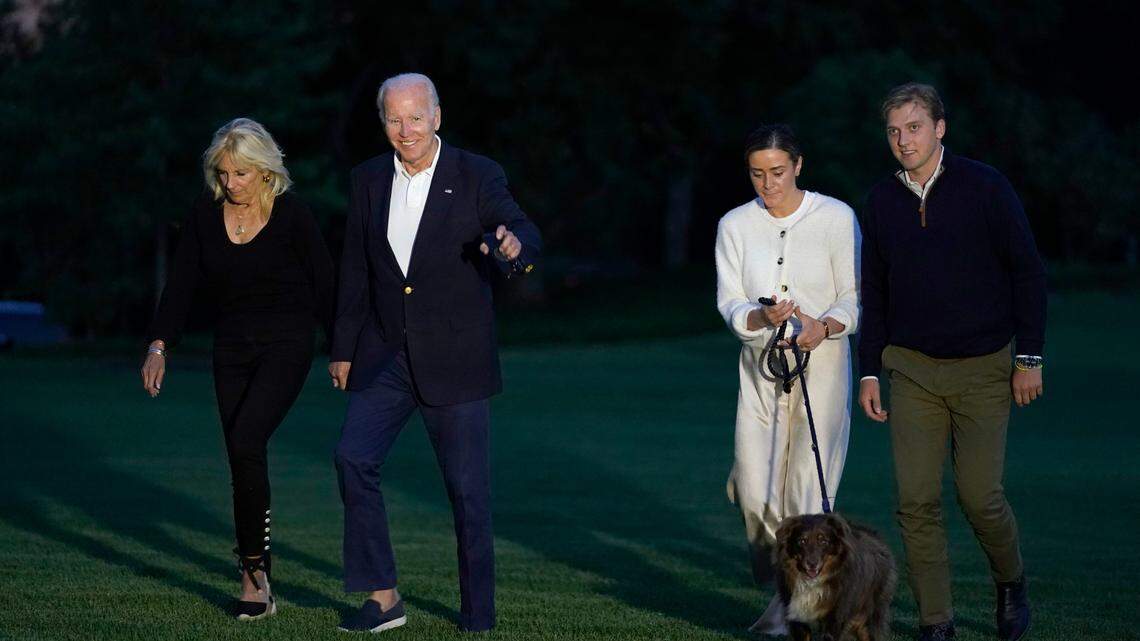 FILE - President Joe Biden and fist lady Jill Biden, left, walk with their granddaughter Naomi Biden and her fiancé Peter Neal, right, and Neal’s dog Charlie, across the South Lawn of the White House in Washington, June 20, 2022. Naomi Biden and Peter Neal are getting married on the South Lawn on Saturday in what will be the 19th wedding in White House history. (AP Photo/Susan Walsh, File)