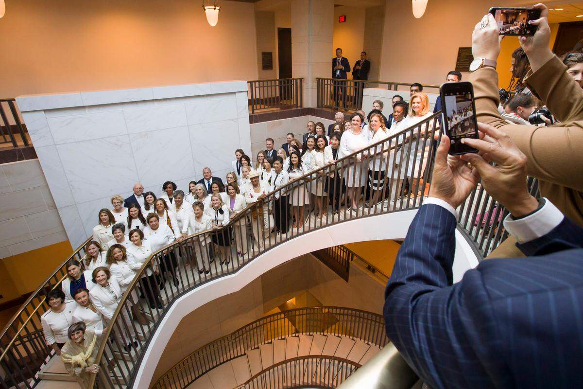 House Speaker Nancy Pelosi of Calif., center, is joined by other women wearing white, as they pose for a group photo before the State of the Union address by President Donald Trump, on Capitol Hill, Tuesday, Feb. 5, 2019 in Washington. (AP Photo/Alex Brandon)