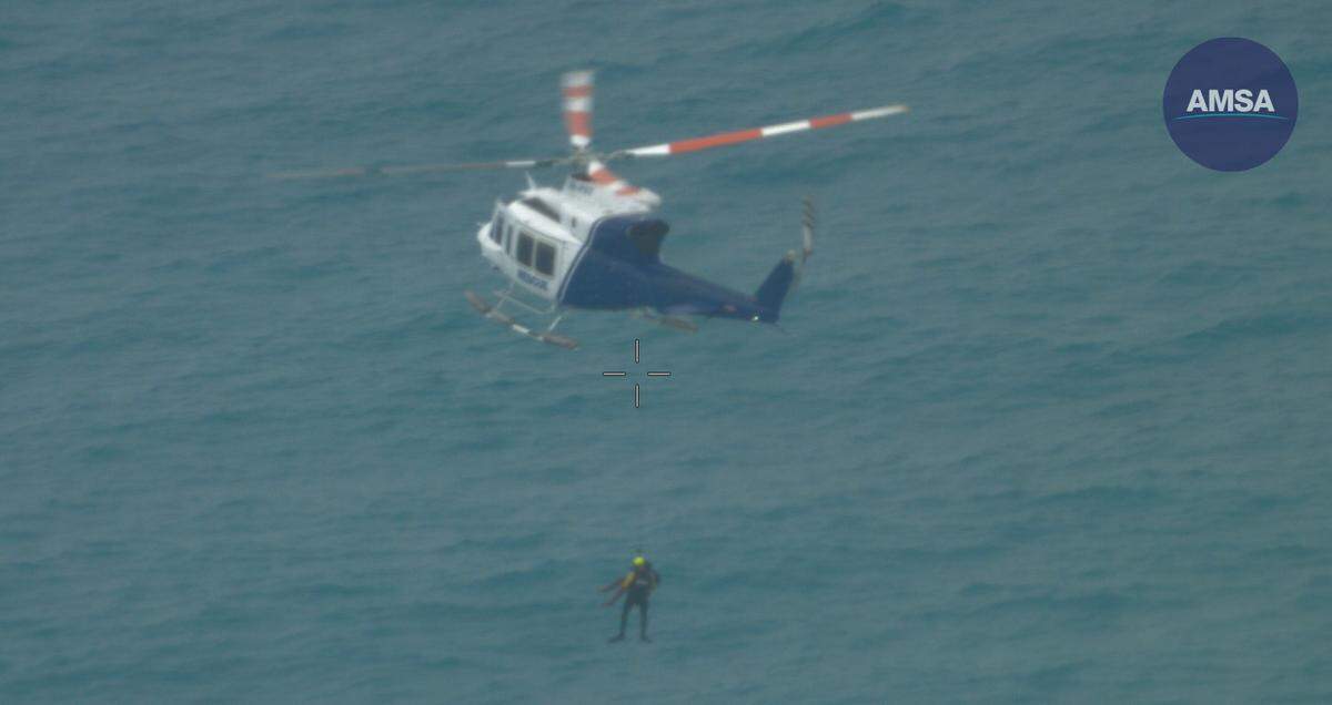 The man was spotted by the crew of an aerial search team and hoisted to safety, officials said.