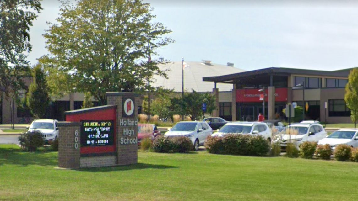 A janitor at a high school in Holland, Michigan, was arrested and charged in connection with a human trafficking operation, police said.