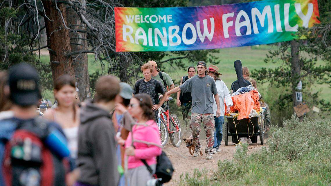 FILE -Rainbow Family members arrive in the Routt National Forest north of Steamboat Springs, Colo., Saturday, July 1, 2006, where as many as 20,000 took part in the annual Rainbow Family gathering. Officials predict that thousands of people will show up for this year’s gathering, which is slated to take place in Colorado and will mark the 50th anniversary of the group. (AP Photo/Ed Andrieski, File)
