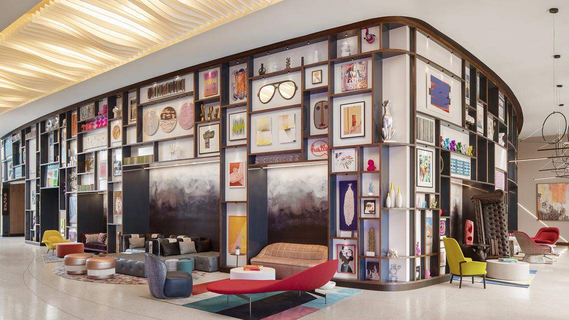 The lobby of the Lake Nona Wave hotel filled with colorful art and bright furniture.