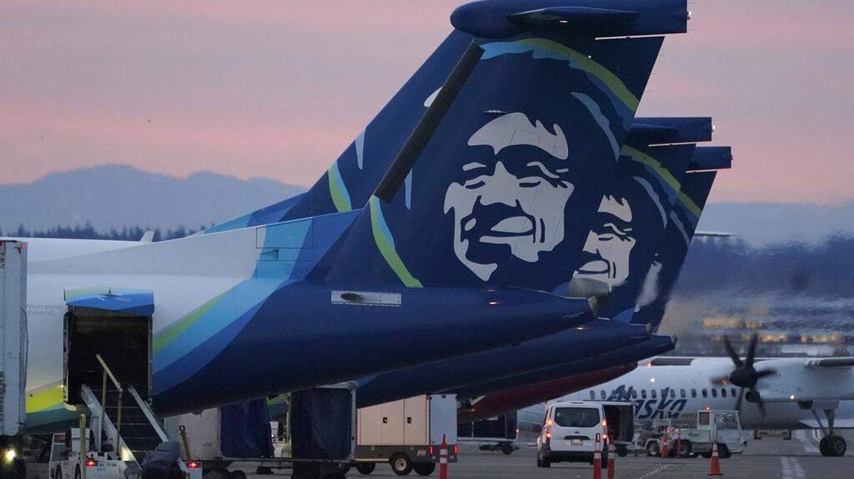 Alaska Airlines planes are shown parked at gates at sunrise, Monday, March 1, 2021 at Seattle-Tacoma International Airport in Seattle. (AP Photo/Ted S. Warren)