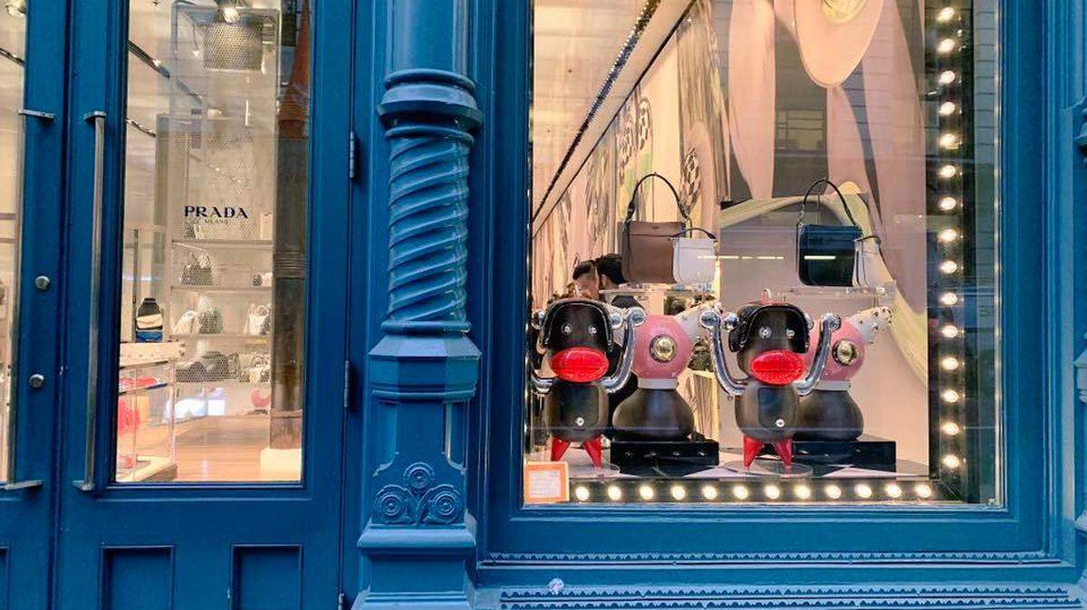 The two monkey-like figurines in the Prada store window in Manhattan’s Soho neighborhood are examples of the “Pradamalia” line of decor that the company says it will pull.