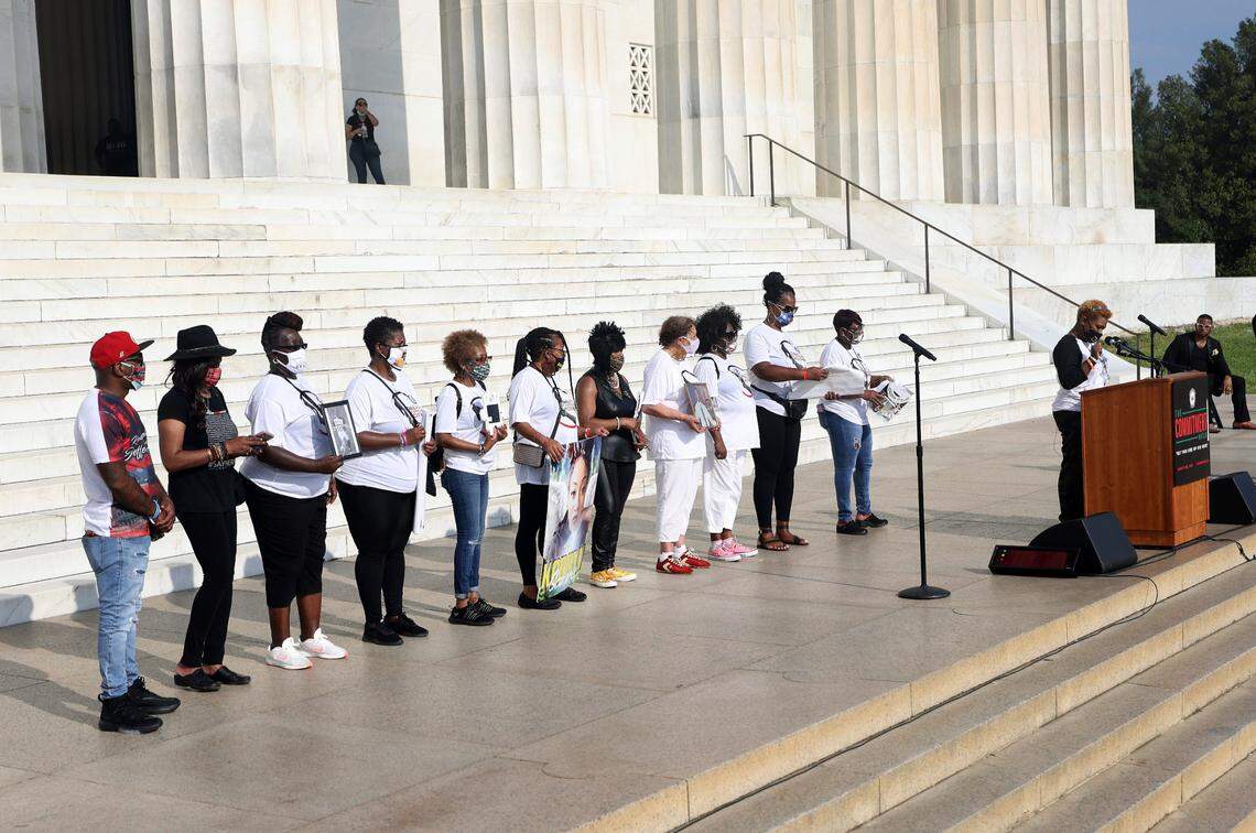 Kenithia Alston, mother of Marquise Alston, right, speaks while joining with 11 other mothers who lost children to police killings as demonstrators gather for the March on Washington, Friday Aug. 28, 2020, in Washington, on the 57th anniversary of the Rev. Martin Luther King Jr.’s “I Have A Dream” speech. (Michael M. Santiago/Pool via AP)