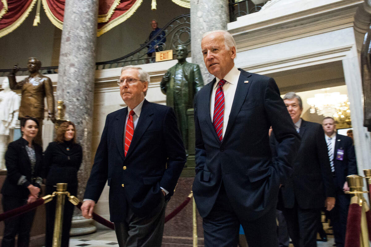 Senate Majority Leader Mitch McConnell (R-Ky.), left, and Vice President Joe Biden, walk through Statuary Hall on their way to a joint session of Congress to count the votes in Washington, Friday, Jan. 6, 2017. It’s official: Congress has tallied the Electoral College votes and Donald Trump has been elected president. (AP Photo/Zach Gibson)