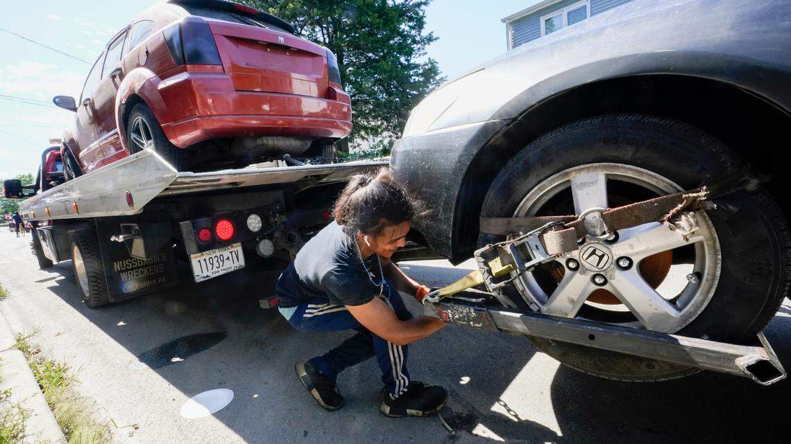 Jose Rivas secures cars damaged by the flood waters to his tow truck after remnants of Hurricane Ida inundated the community, Saturday, Sept. 4, 2021, in Mamaroneck, N.Y. More than four days after the hurricane blew ashore in Louisiana, Ida’s rainy remains hit the Northeast with stunning fury on Wednesday and Thursday, submerging cars, swamping subway stations and basement apartments and drowning scores of people in five states. (AP Photo/Mary Altaffer)