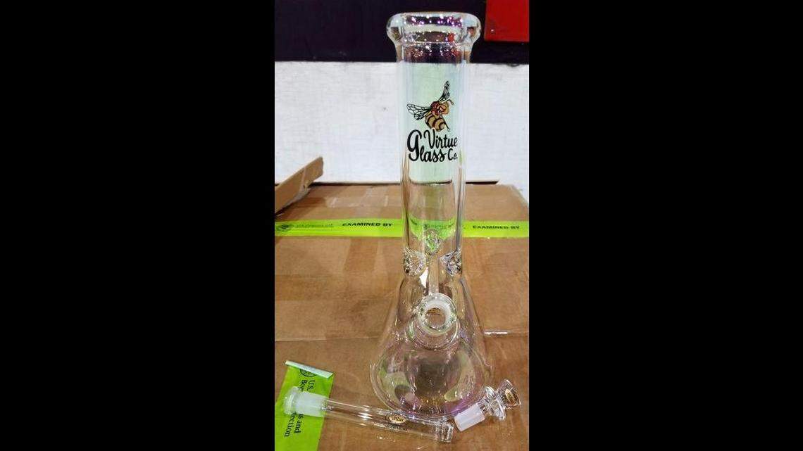 Customs officers seized thousands in unreported currency and a shipment of glass bongs from a Washington, DC airport, U.S. Customs and Border Protection said.