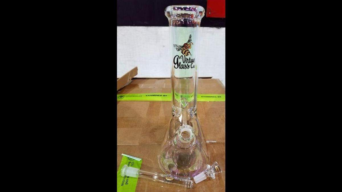 Customs officers seized thousands in unreported currency and a shipment of glass bongs from a Washington, DC airport, U.S. Customs and Border Protection said.
