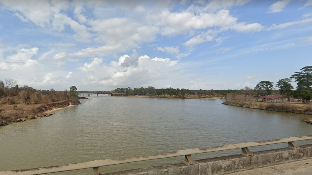 Divers recovered a body from the San Jacinto River one day after a man vanished there while trying to save a drowning woman, police said.