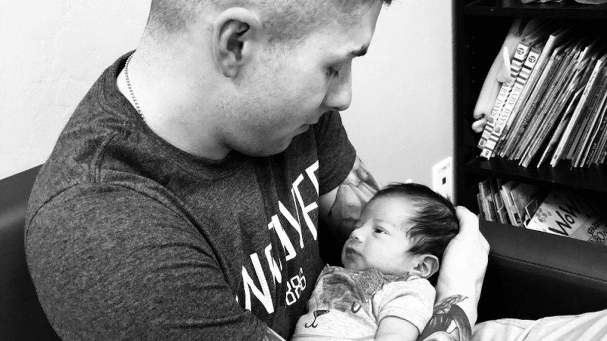 U.S. Army Sgt. Steven Garcia holds the baby boy his wife told him died during birth.
