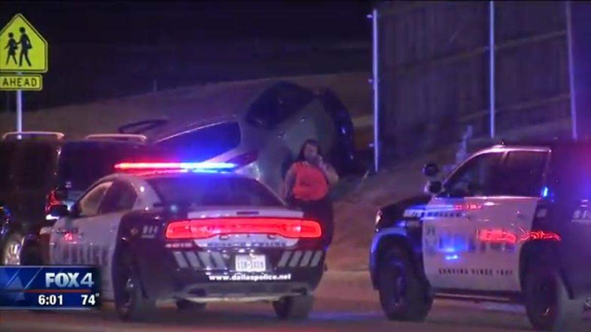 Michelle Booker-Hicks' SUV sits on a grassy hill after a carjacker crashed it into a utility pole and a fence.