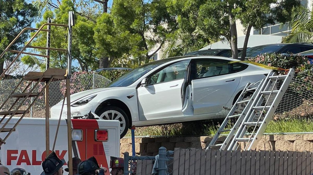 Three people were injured after a Tesla landed on top of an ambulance in San Diego.