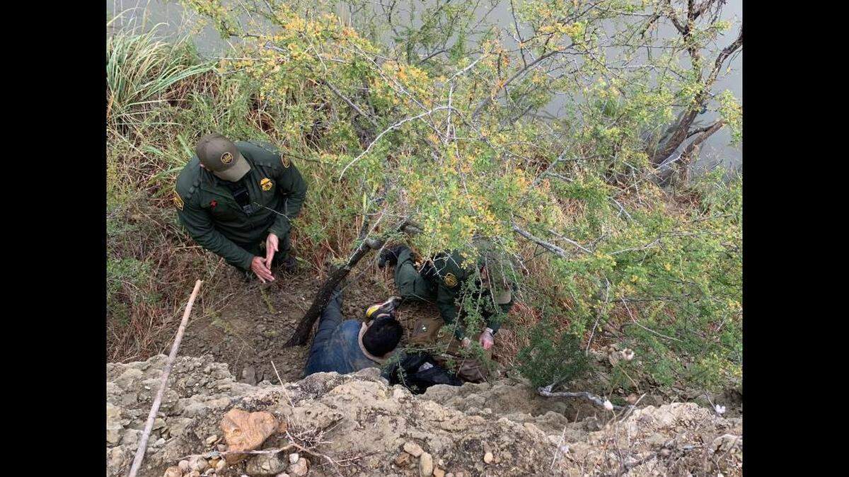Border agents assist a man who fell 20 feet from a cliff near Eagle Pass, Texas.