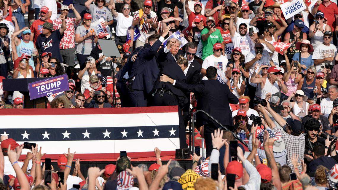 Former President Donald Trump is surrounded by Secret Service agents at a campaign rally in Butler, Pa, on Saturday, July, 13, 2024. Trump was escorted off the stage by Secret Service agents and into his motorcade just minutes into his rally in Butler, Pa., after a series gunshots rang out. (Eric Lee/The New York Times)