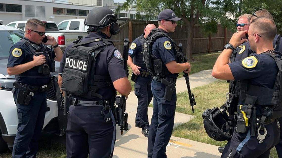 A woman was taken hostage at gunpoint after investigating cries for help heard at her neighbor’s home, Iowa police said.
