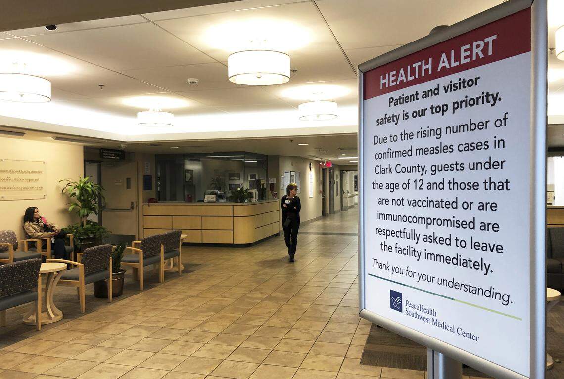 A sign prohibiting all children under 12 and unvaccinated adults stands at the entrance to PeaceHealth Southwest Medical Center in Vancouver, Wash. A measles outbreak near Portland has sickened dozens of people in Oregon and Washington, with several more cases suspected, and public health officials scrambling to contain the virus say low vaccination rates are making the situation worse.
