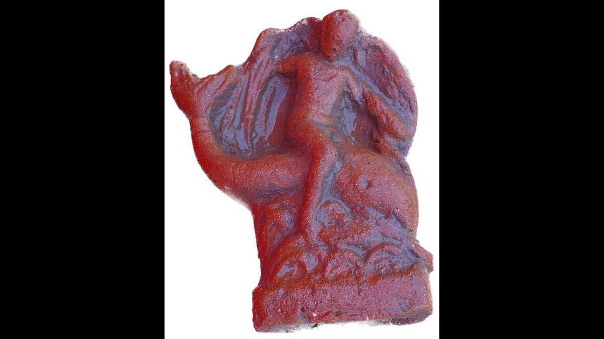 A figurine of the god Eros riding a dolphin was unearthed among a trove of artifacts at an ancient Greek temple in Italy, archaeologists said.