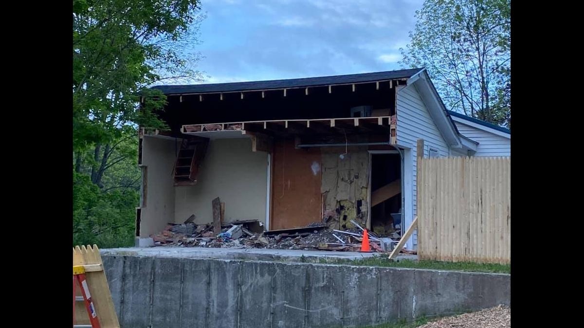 Debris from the cutting was piled back into the garage after it was cut in half. Photo from Gabriel Brawn on Facebook.