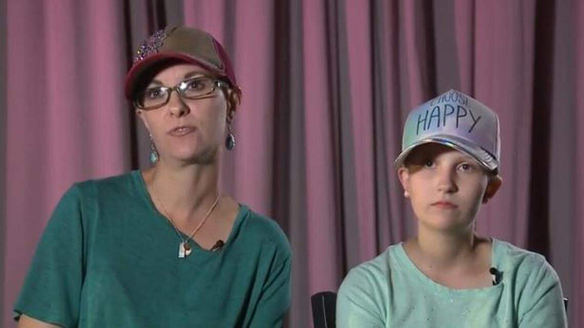 Bella Thurston, right, is battling a brain and spine tumor. The 13-year-old walked away from taking school pictures when a Lifetouch photographer told her she had to take her hat off.