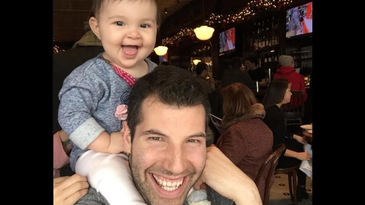 Matt Tomaszewski and his 17-month-old daughter, Chloe. Tomaszewski’s family was visiting his parents when he dashed into the water to save people caught in a riptide.