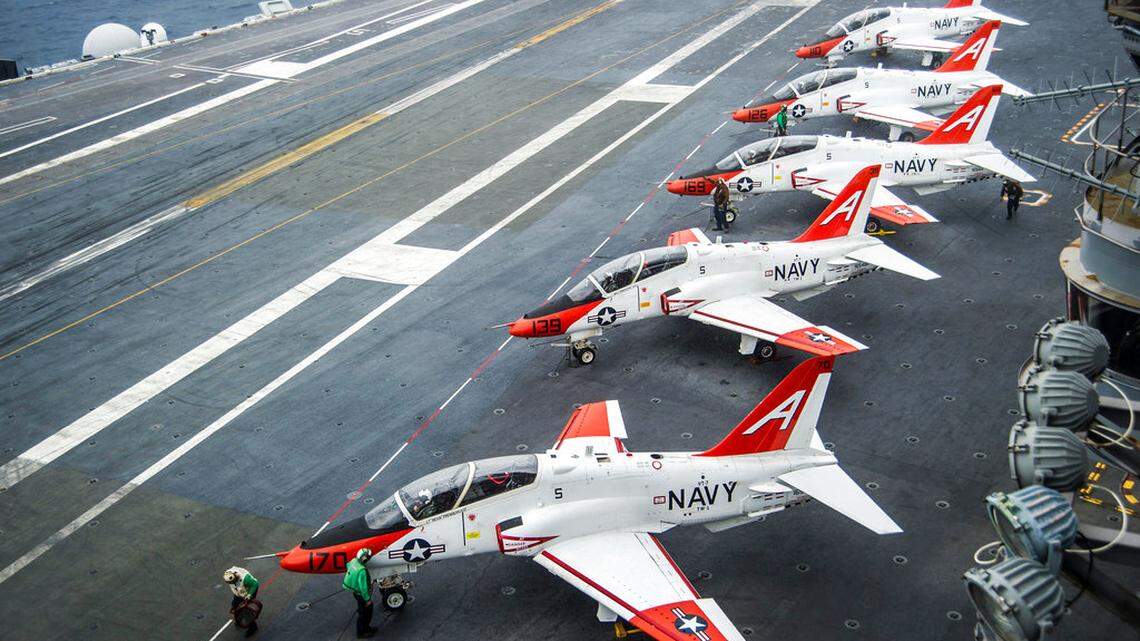 FILE - In this Dec. 10, 2016, file photo provided by the U.S. Navy, pilots perform pre-flight procedures in T-45C Goshawks from Training Air Wing One on the flight deck of the aircraft carrier USS George Washington, docked in Norfolk, Va. (Petty Officer 2nd Class Bryan Mai/U.S. Navy via AP, File)