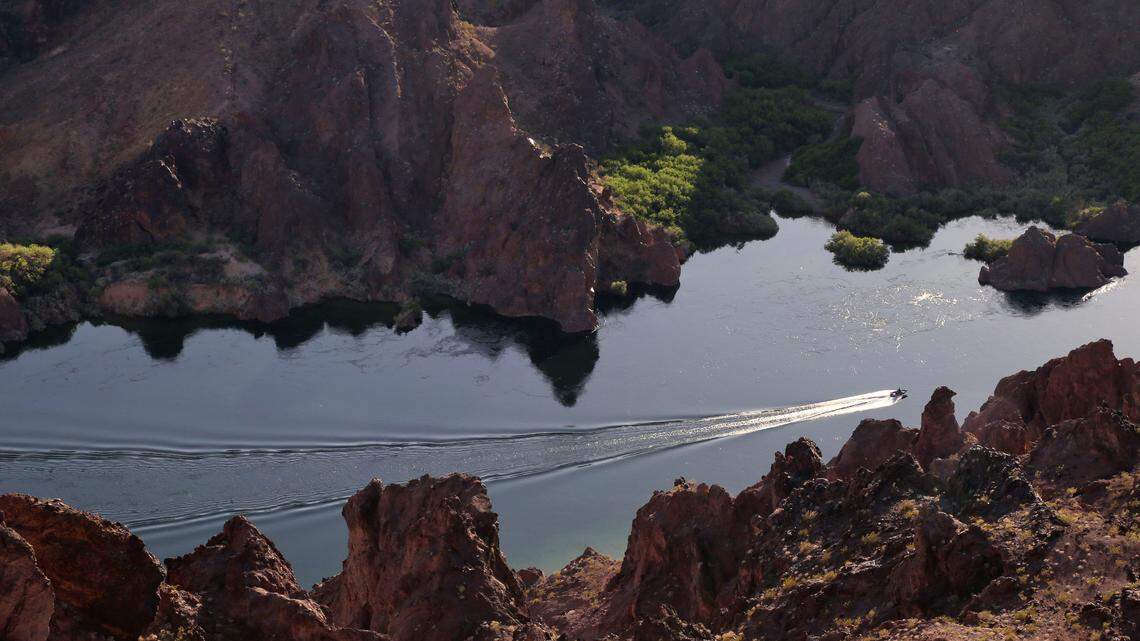In this April 12, 2013, file photo, a patrol boat makes its way upstream along the Colorado River in Black Canyon just south of Hoover Dam near Willow Beach, Ariz. (AP Photo/Julie Jacobson, File)