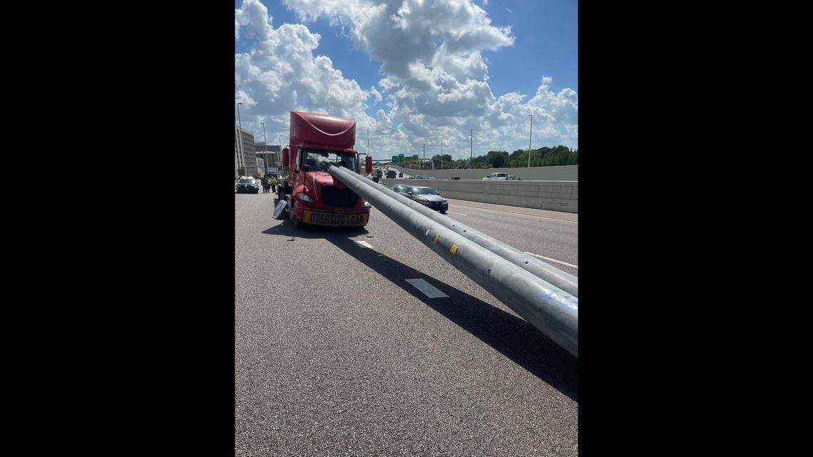 Two utility poles being hauled by a tractor-trailer broke free and crashed through the cab’s windshield when the driver braked, Florida police said.