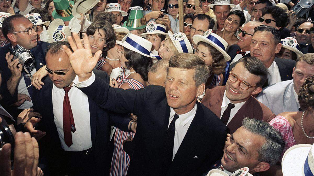 Sen. John F. Kennedy makes his way through a crowd of supporters and journalists as he arrives in Los Angeles, July 9, 1960, for the Democratic National Convention.