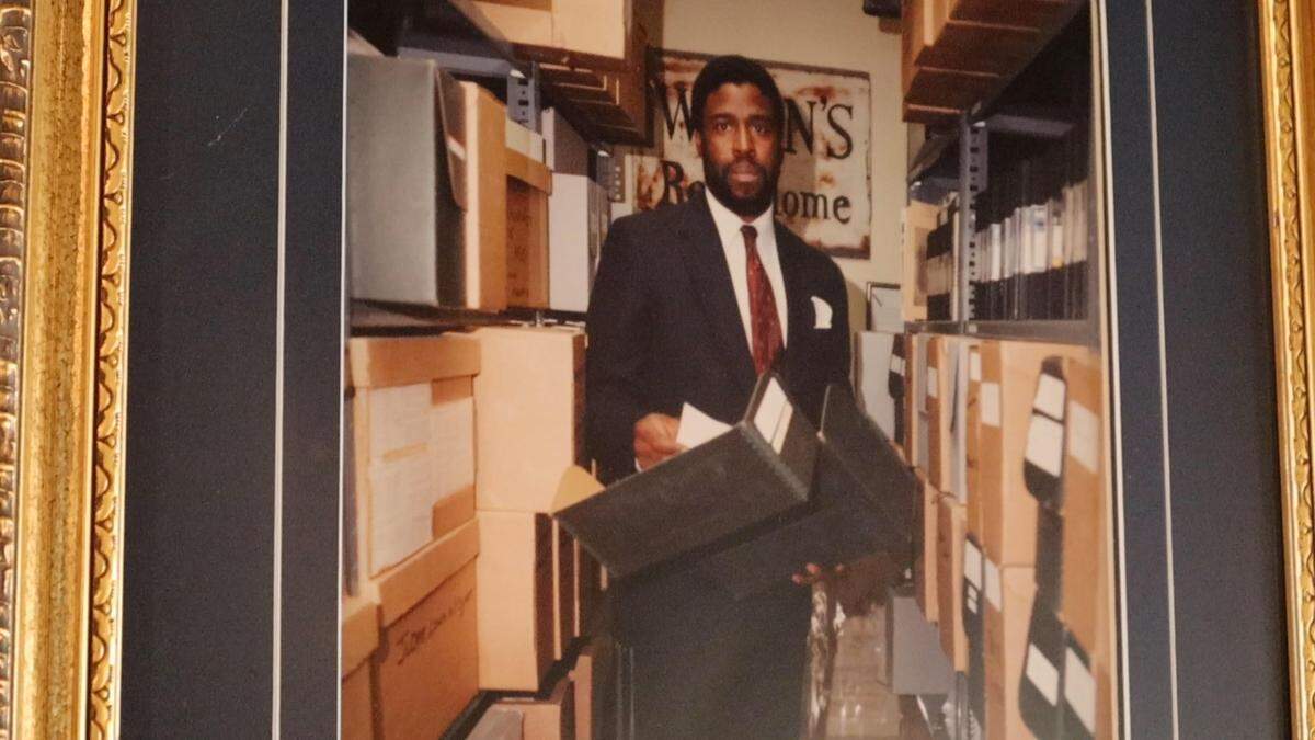 Horace M. Peterson III, the founder of The Black Archives of Mid-America, standing among artifacts and records that are part of the museum's collection.