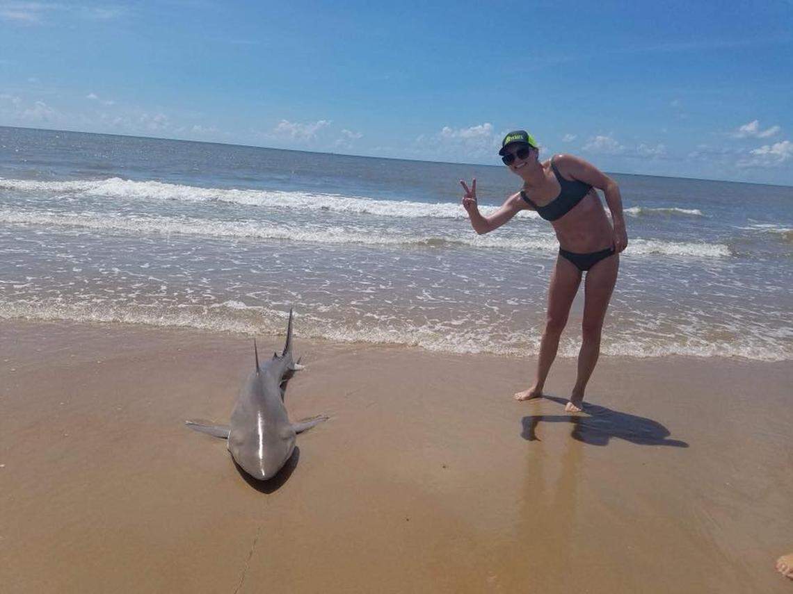 Lauren Biggers gets as close as comfort allows to her catch before she released the 6-foot blacktip shark back into the Gulf of Mexico.
