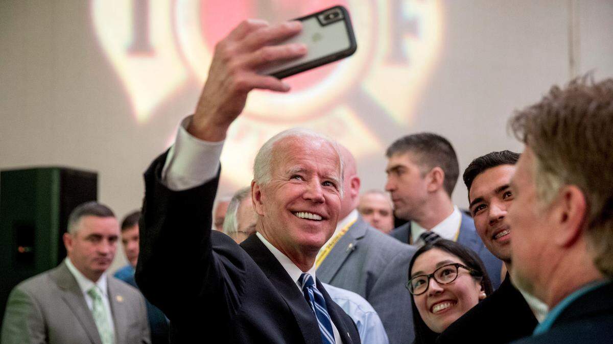 Former Vice President Joe Biden takes a photograph with members of the audience after speaking to the International Association of Firefighters at the Hyatt Regency on Capitol Hill in Washington, Tuesday, March 12, 2019, amid growing expectations he’ll soon announce he’s running for president. (AP Photo/Andrew Harnik)