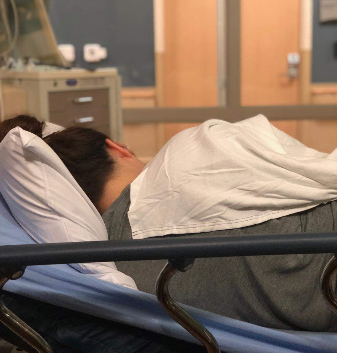 Katie Holley lies on a hospital bed during her visit to a Melbourne, Fla. emergency room on April 14.