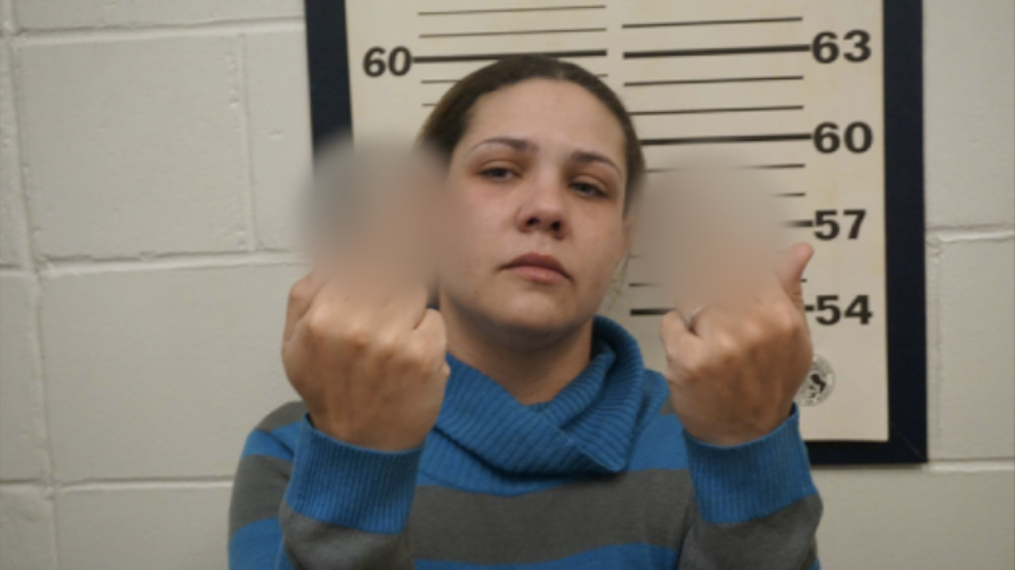 Spotswood, NJ, police posted Shana Hilsman’s mugshot on Facebook after she was arrested on burglary charges following numerous late-night car break-ins. She flips off the camera with both middle fingers.