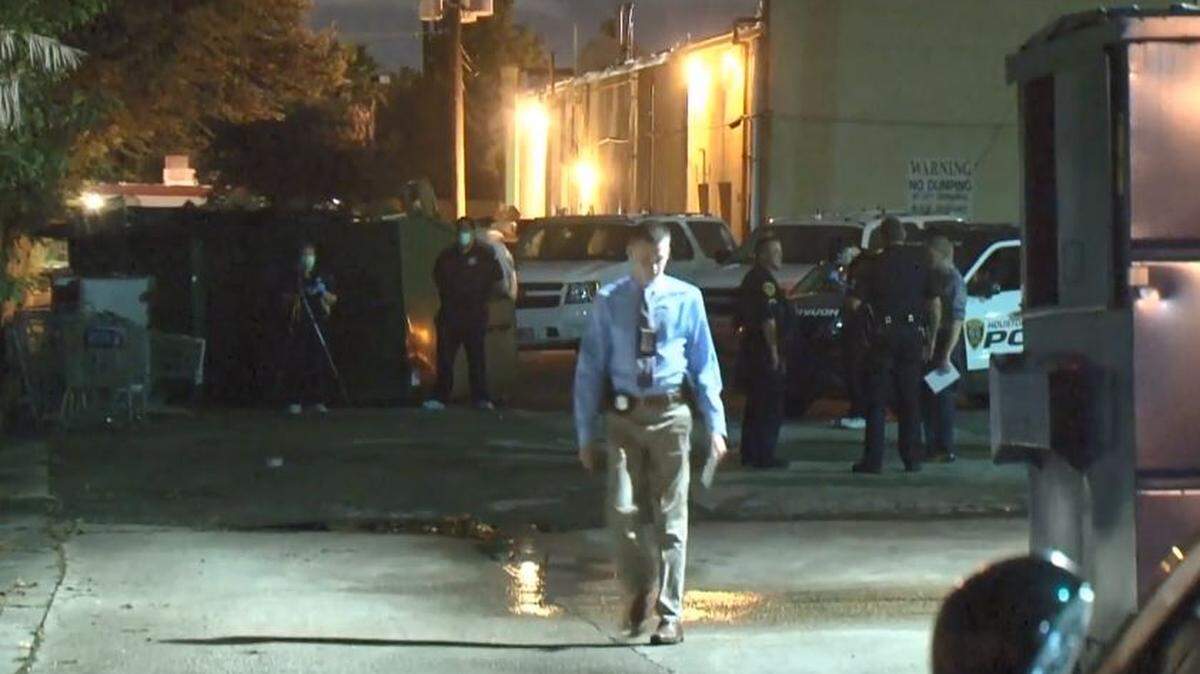 Investigators go over the scene in southeast Houston where police say a woman stabbed herself inside a Dumpster at a shopping center after she was sexually assaulted.