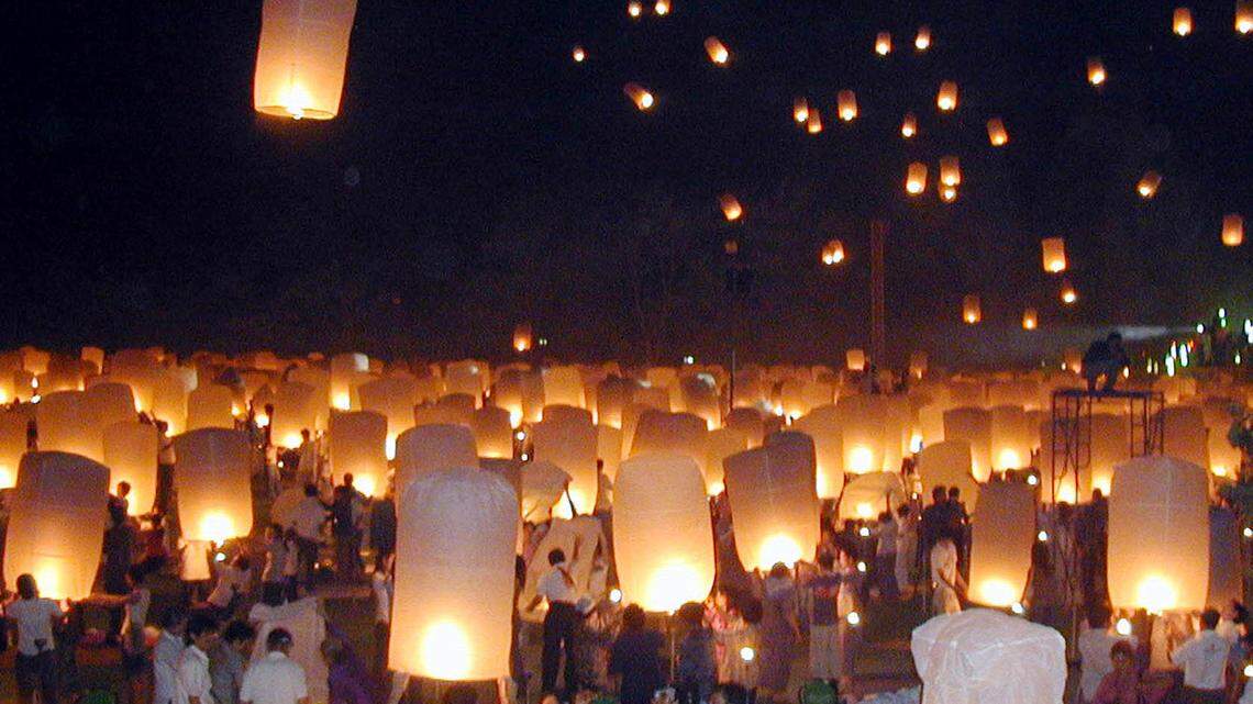 Residents and tourists prepare to release the lanterns in to the sky during a celebration prior the Loy Kratong or floating festival in Chiang Mai province, northern Thailand in 2005. A pagoda caught fire at another lantern festival in Chiang Mai on Nov. 8, 2022.