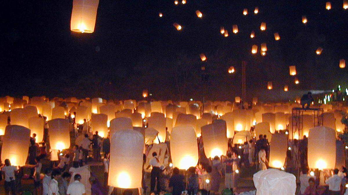Residents and tourists prepare to release the lanterns in to the sky during a celebration prior the Loy Kratong or floating festival in Chiang Mai province, northern Thailand in 2005. A pagoda caught fire at another lantern festival in Chiang Mai on Nov. 8, 2022.