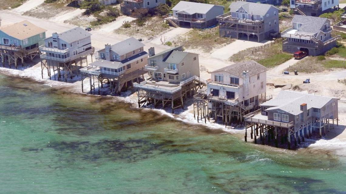 Hurricane Irene hammered the Outer Banks of North Carolina in August of 2011, eroding beaches and leaving several waterfront homes, including these in Nags Head, exposed to the waves. Authorities later condemned these homes, and they have since been removed. Scientists say sea-level rise is accelerating in North Carolina and other Southeast states, putting thousands of waterfront homes at risk.