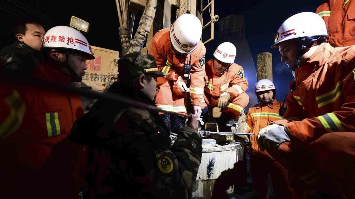 In this Dec. 28, 2015 photo provided by China's Xinhua News Agency, rescuers try to contact the trapped people at a collapsed mine in Pingyi County, east China's Shandong Province.