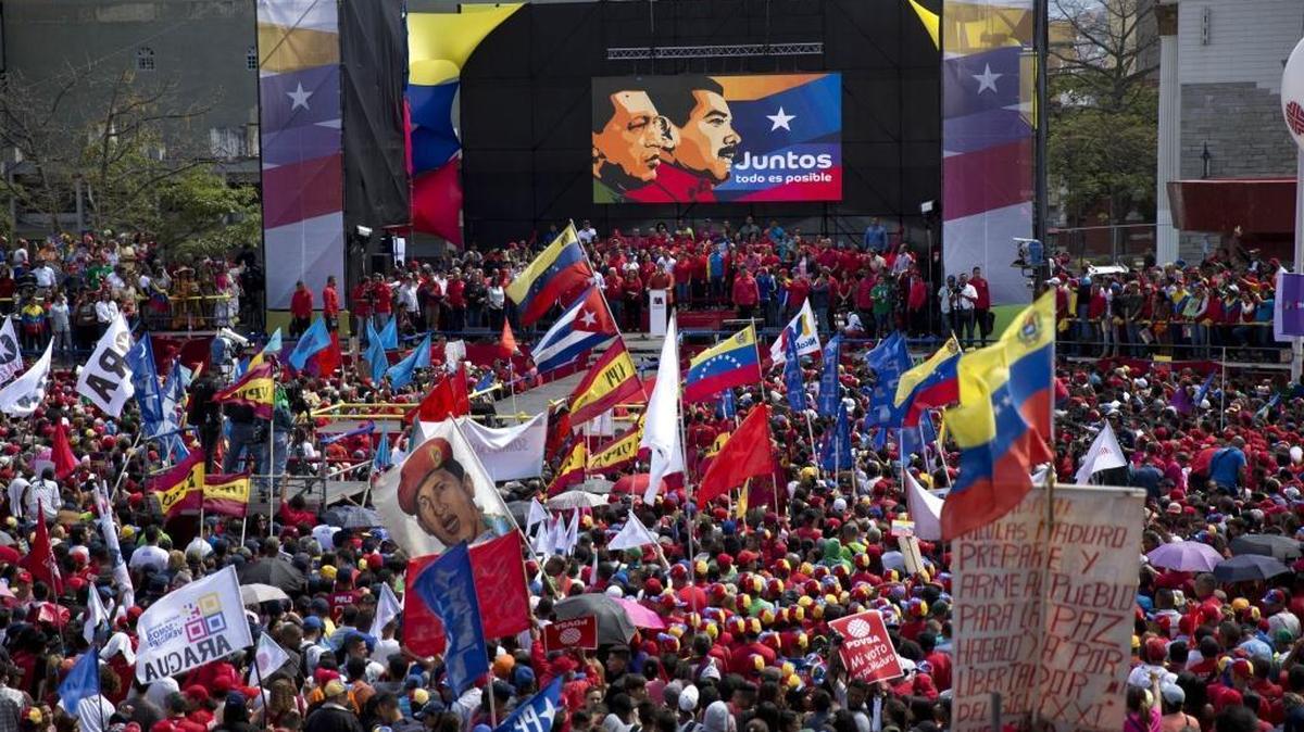 Supporters gather at Diego Ibarra square to listen Venezuela's President Nicolas Maduro speak after a ceremony formalizing Maduro's candidacy as a candidate for the upcoming presidential election, in Caracas, Venezuela, Tuesday, Feb. 27, 2018.