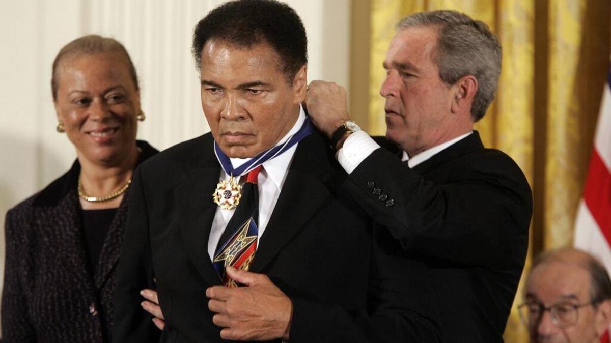 President George W. Bush presents boxing legend Muhammad Ali the Presidential Medal of Freedom at the White House in 2005.