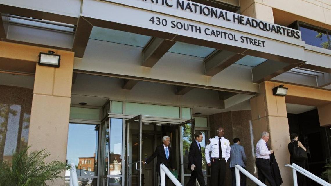 In this June 14, 2016 file photo, people stand outside the Democratic National Committee (DNC) headquarters in Washington. (AP Photo/Paul Holston, File)