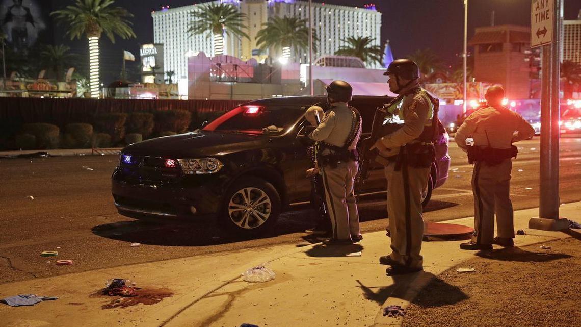 Police stand at the scene of a shooting along the Las Vegas Strip, Monday, Oct. 2, 2017, in Las Vegas. Multiple victims were being transported to hospitals after a shooting late Sunday at a music festival on the Las Vegas Strip. (AP Photo/John Locher)